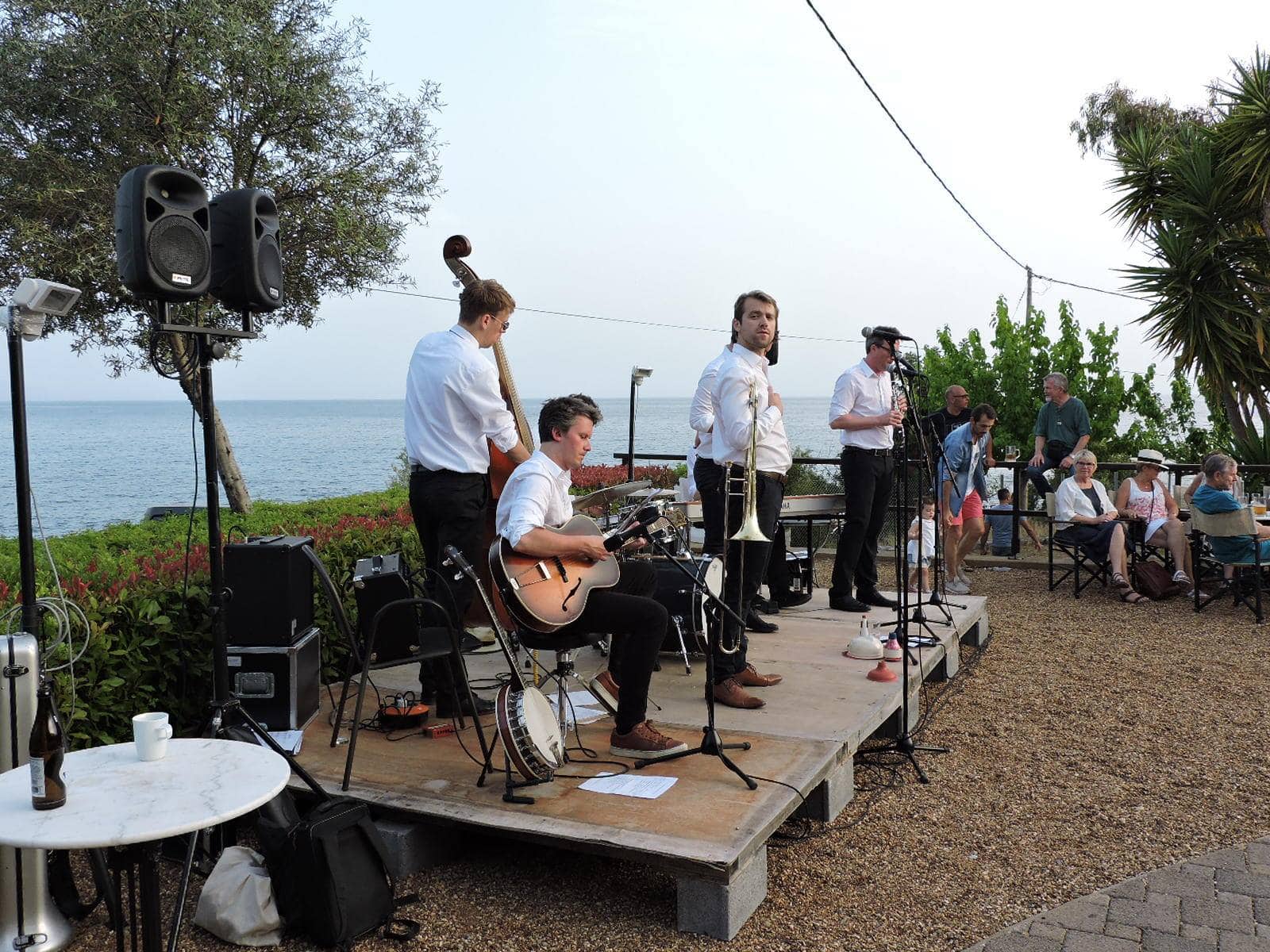 Jazz band plays music on stage overlooking the sea